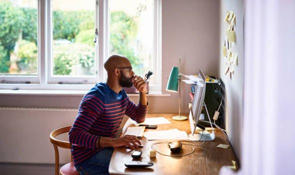 Un homme travaillant à domicile sur son ordinateur portable