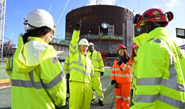 Boris Johnson rencontre des apprentis lors d'une visite sur le chantier de construction de la centrale nucléaire de Hinkley Point C