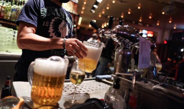 Un serveur sert des bières dans un bar à la veille de la fermeture obligatoire des bars à Bruxelles