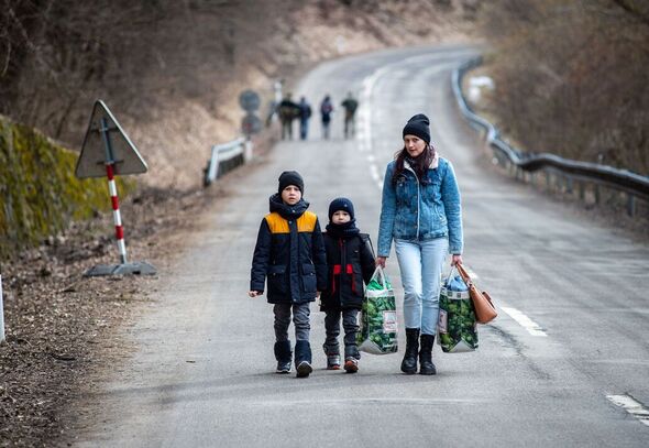 Une femme et des enfants marchant dans une rue
